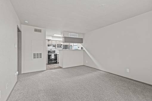 A large, empty room with a carpeted floor and white walls.at Rock 35, Texas