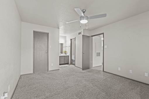 A spacious room with a ceiling fan and carpeted floor.at Rock 35, Round Rock, TX