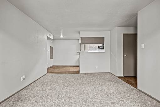 A spacious room with a carpeted floor and a window with blinds.at Rock 35, Round Rock, 78681
