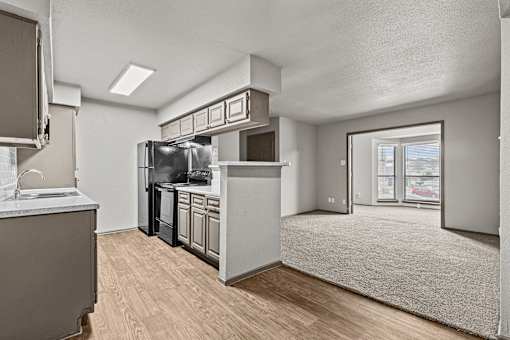 A kitchen with a refrigerator, microwave, and oven.at Rock 35, Round Rock, 78681