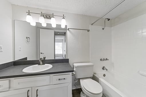 a bathroom with a sink toilet and bathtub at Vesper, Dallas, TX