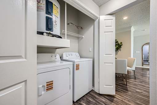 A small laundry room with a washer and dryer.