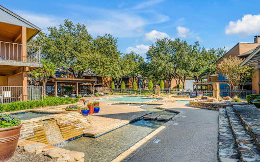A residential area with a pool and a small waterfall.