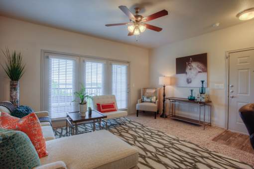 A living room with a couch, chair, and a rug.