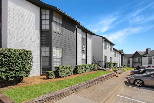 A row of houses with a car parked in front of them.