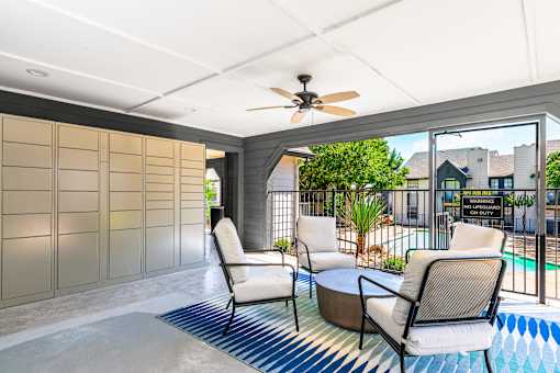 A patio with a pool and chairs.