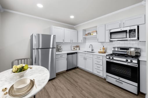 a kitchen with white cabinetry and stainless steel appliances  at Sunset Heights, San Antonio, Texas