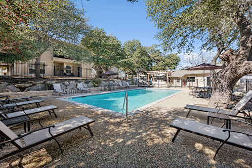 pool surrounded by house at Crosspoint Oaks at Boerne, Texas