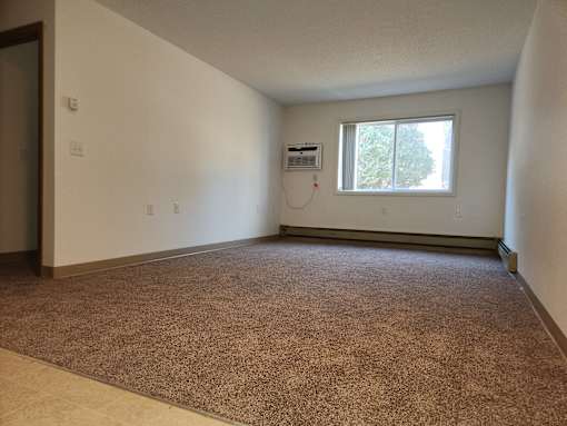 the living room of an empty house with a window