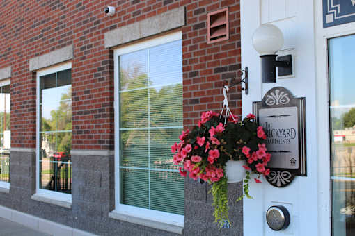 Front door of Brickyard Apartments with sign that says "Brickyard Apartments"