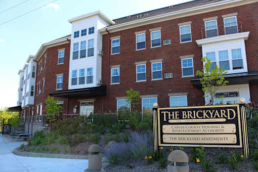 Front of the Brickyard Apartments with sign.
