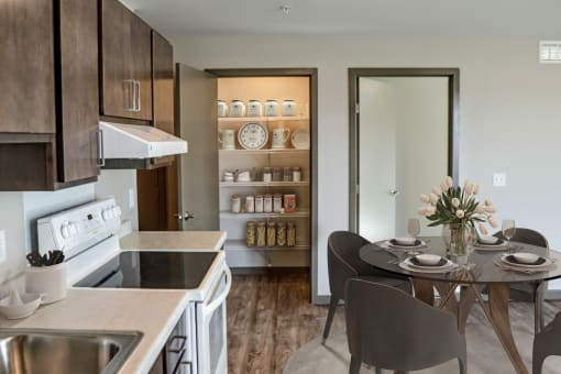 a kitchen and dining area leading to a pantry