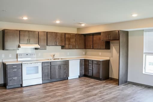a kitchen with dark wood cabinets and white appliances