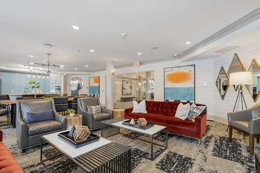 A living room with a red couch and a coffee table.