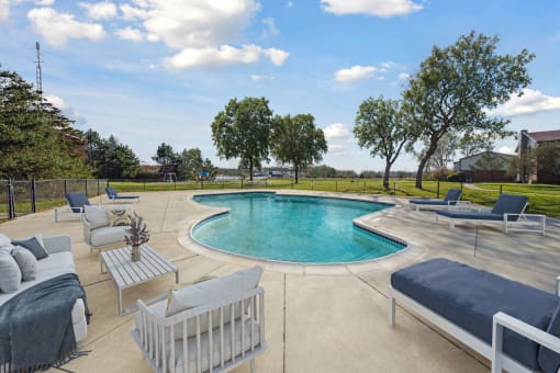 a pool and lounge area with furniture around it