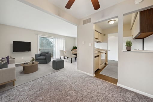 a living room with a kitchen and a dining room