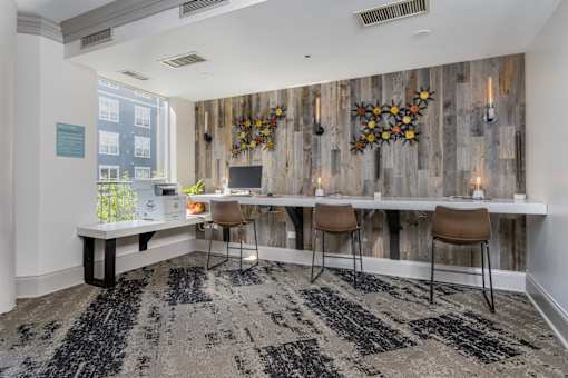 A room with a wooden wall and a black and white rug.