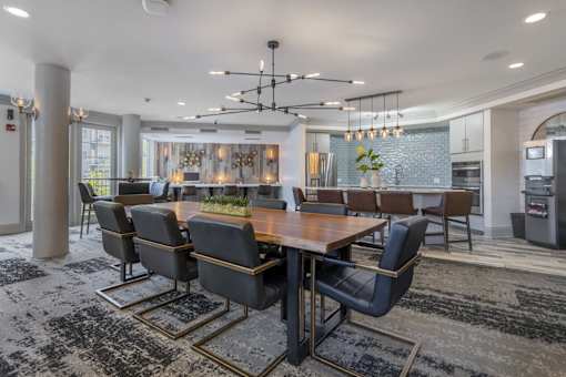 A modern dining room with a large table and chairs.