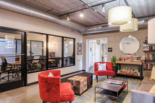 A living room with a red chair and a coffee table.