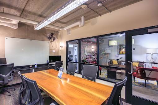 A conference room with a long table and chairs.
