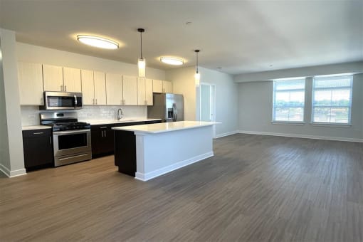 an empty room with a counter with sinks and microwaves