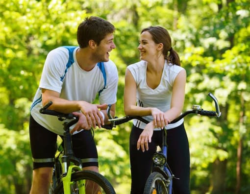 a man and a woman standing next to bikes