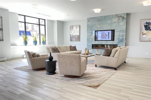 a living room with couches and chairs and a fireplace
