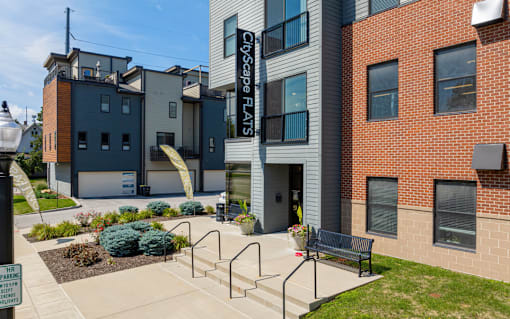 A building with the sign "CityScape Flats" is shown with a blue sky in the background.
