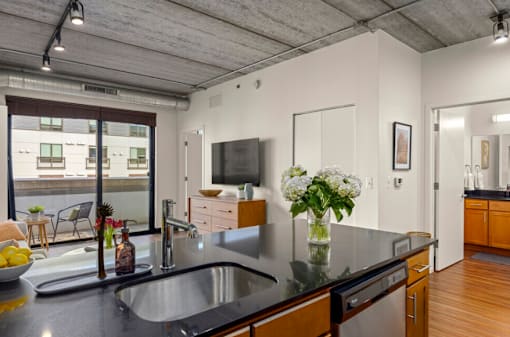 Enjoy an open-concept kitchen floorplan featuring sleek quartz countertops and beautiful plank flooring throughout