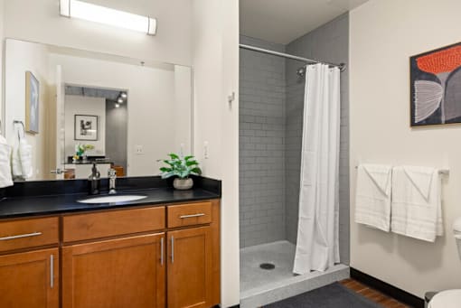 Oversized Showers with Subway Tile Surrounds and Spacious Bathroom Vanities