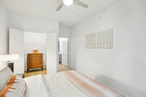 Bright bedroom with ceiling fan and wood flooring at Matador Apartments, Austin, TX