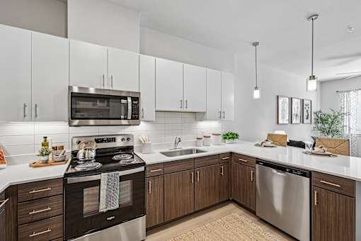 A modern kitchen with a stove top oven and microwave.