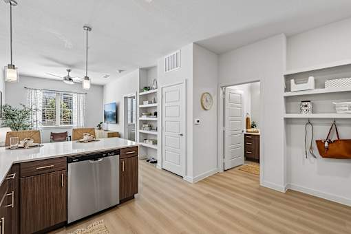 A modern kitchen with wooden cabinets and a stainless steel dishwasher.