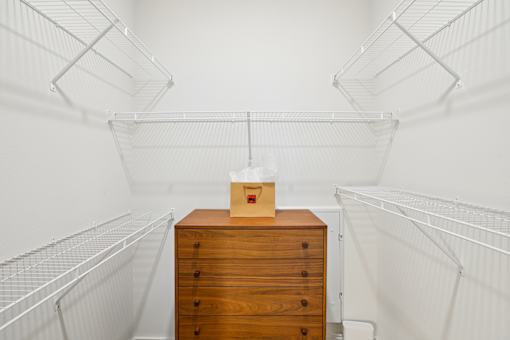 Walk-in closet with wire shelving and dresser at Matador Apartments, Texas