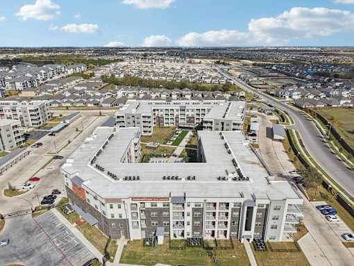 Aerial view of apartment community with courtyard at Cantarra Apartments, Manor, 78653