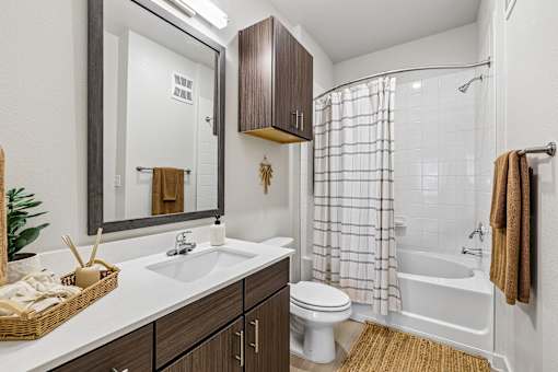 A bathroom with a white sink, toilet, and bathtub.