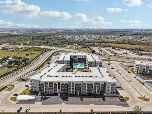 Aerial view of apartment community with pool at Cantarra Apartments, Texas