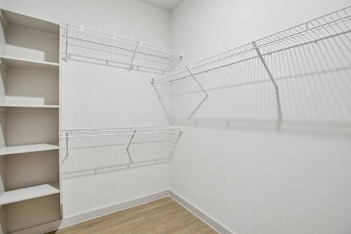 Empty white shelves in a room. at ThreeTwenty at the Vybe Apartments, Kyle, TX