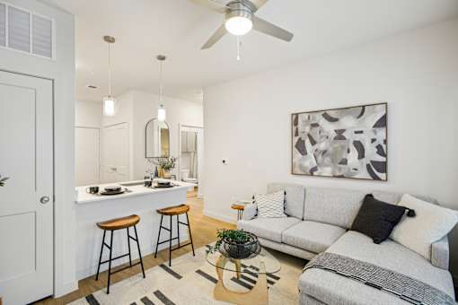 Living area with sectional sofa and breakfast bar at Matador Apartments, Austin, Texas