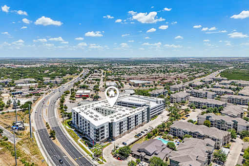 A bird's eye view of a city with a large building in the center.