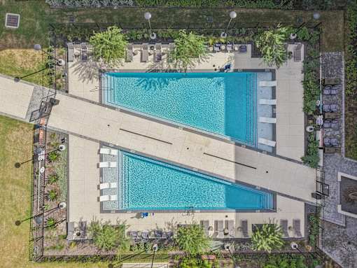 Dual lap pools with sundeck from above at Cantarra Apartments, Texas, 78653