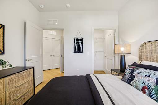 Bedroom with cane headboard and modern lamp at Matador Apartments, Texas, 78745