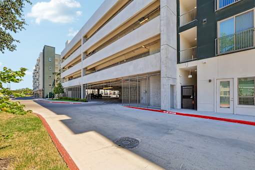 A parking garage with a red line on the sidewalk.