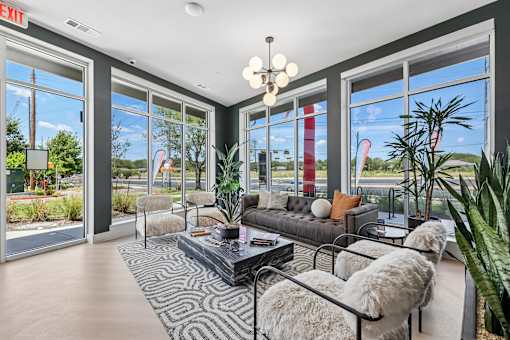 A living room with a couch, chairs, and a coffee table.