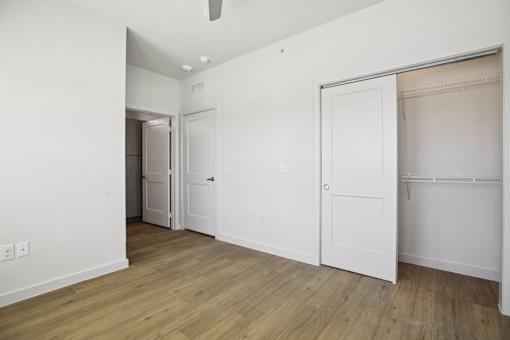 Empty bedroom with open closet and wood flooring 1 at Matador Apartments, Austin, 78745