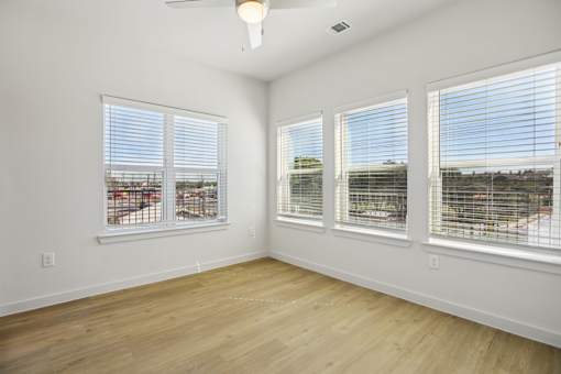 Empty bedroom with large corner windows at Matador Apartments, Texas, 78745