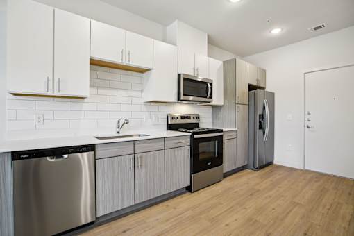 Kitchen with two tone cabinetry and white subway tile at Matador Apartments, Austin, TX 78745