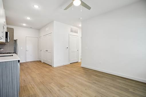 Open living area with ceiling fan and hardwood floors at Matador Apartments, Austin, TX
