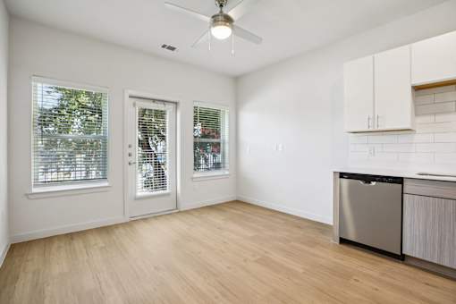 Kitchen area with stainless dishwasher and back door at Matador Apartments, Austin, Texas
