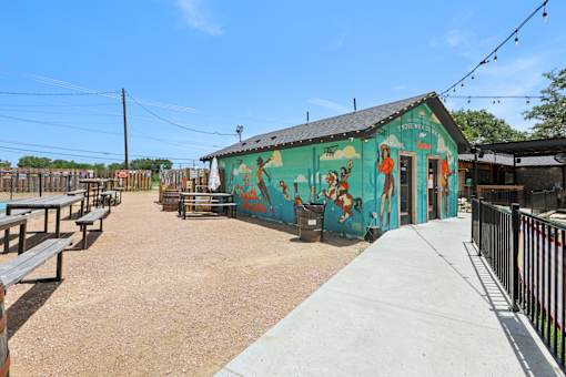 A mural on a building is painted in bright colors. at Park South Apartments, Texas, 78748
